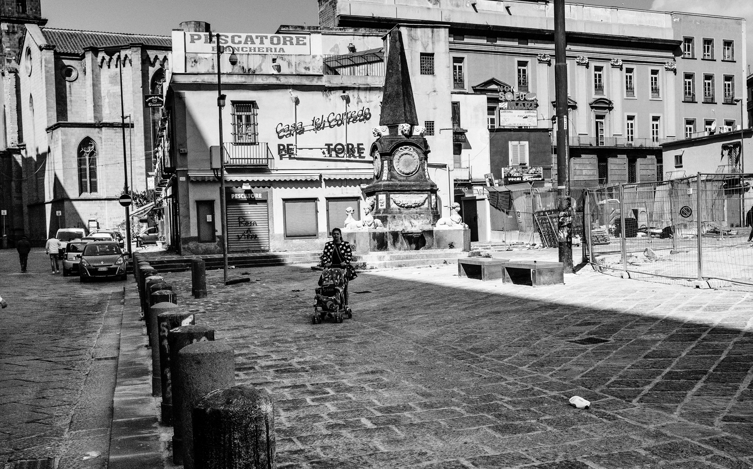 A Roma woman pushes a stroller carrying a loudspeaker through the empty city. The stillness and silence that reigned in the streets felt unreal during the lockdown days